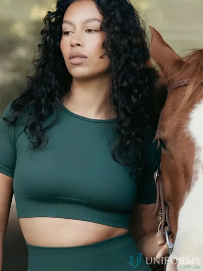 Woman in green Seamless Cropped Emerald Tee with round neck, perfect for uniforms