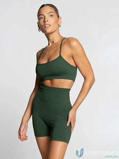 Woman in green athletic set with flattering scoop neckline wearing Seamless Emerald Active Crop