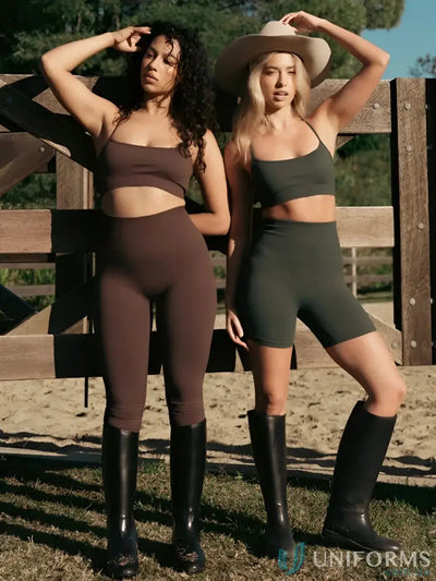 Two women in athletic wear and riding boots showcasing Seamless Invicible Scrunch Espresso Leggings, perfect work uniforms