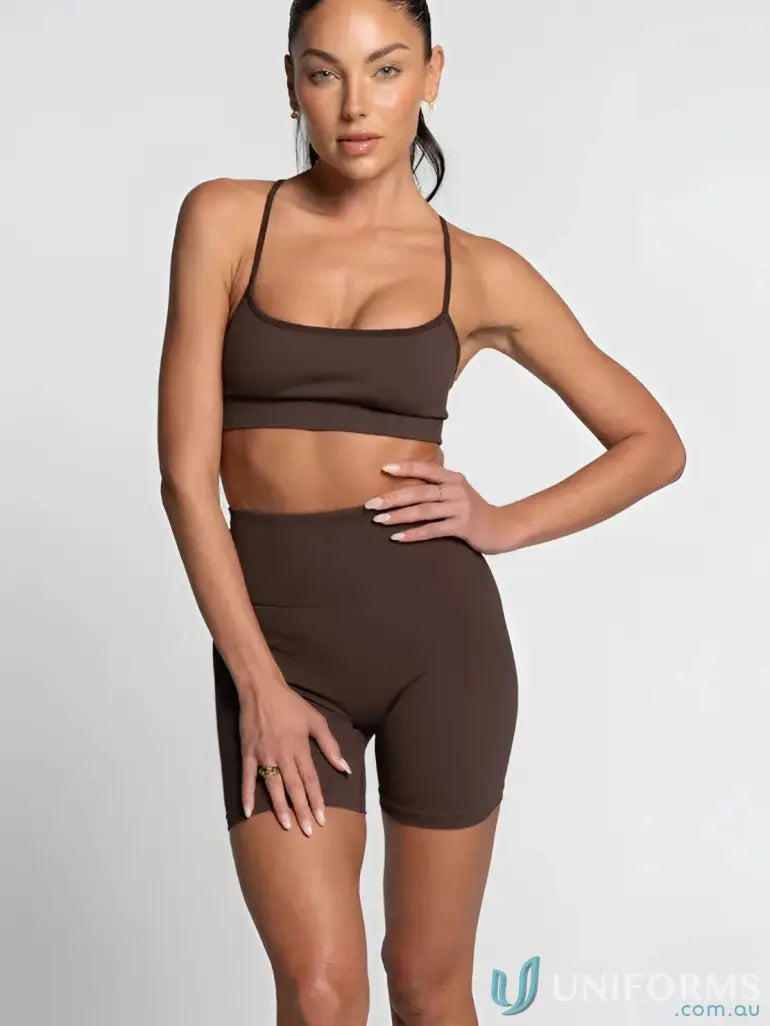 Brown seamless athletic set with high-waisted shorts and matching sports bra, likely from a fitness brand.