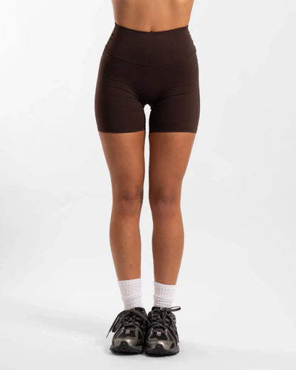 Brown seamless invicible scrunch onyx shorts with white socks and black shoes
