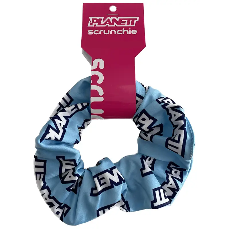 Sky Scrunchie in blue white planet design on pink packaging