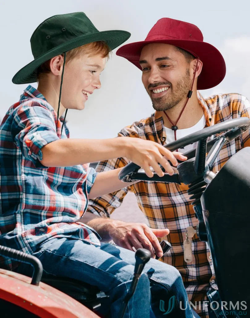Father and son on tractor wearing the h1026 Slouch Hat with sun protection