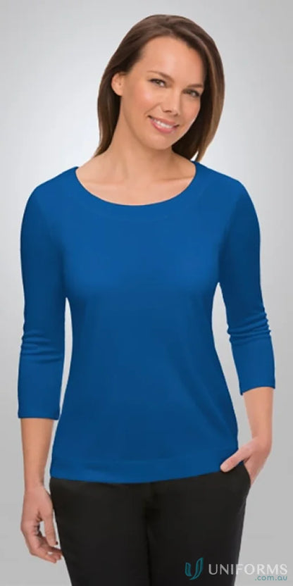 Woman in a blue stretch Smartknit Top, perfect for uniforms and workwear
