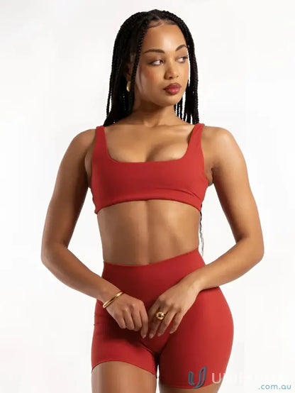 Red athletic bra and shorts set with square neckline for stylish activewear look