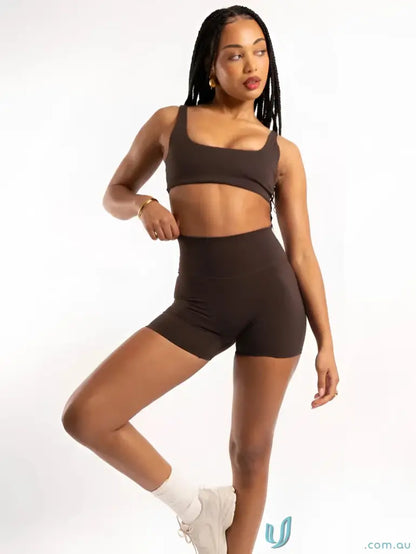 Woman in brown athletic set with square neckline perfect for stylish uniforms