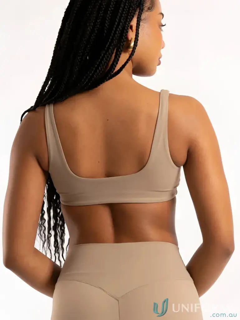 Tan athletic bra and leggings set with square neckline, perfect for workout uniforms