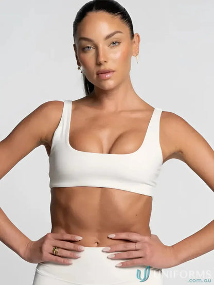 White athletic crop top with square neckline, perfect for sports uniforms
