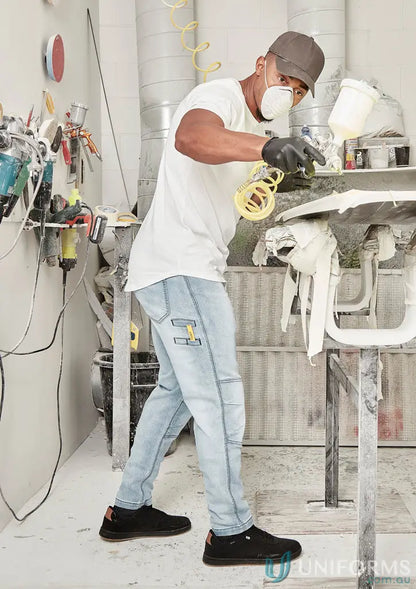 Man spray painting in streetworx stretch jean for demand performance style