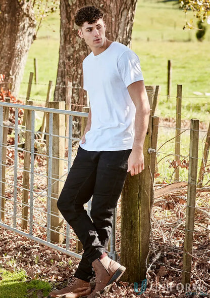 Man in white T-shirt and black jeans wearing Streetworx Stretch Jean for demand performance