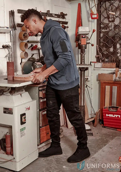Man sanding wood in workshop wearing Streetworx Stretch Jean for demand performance