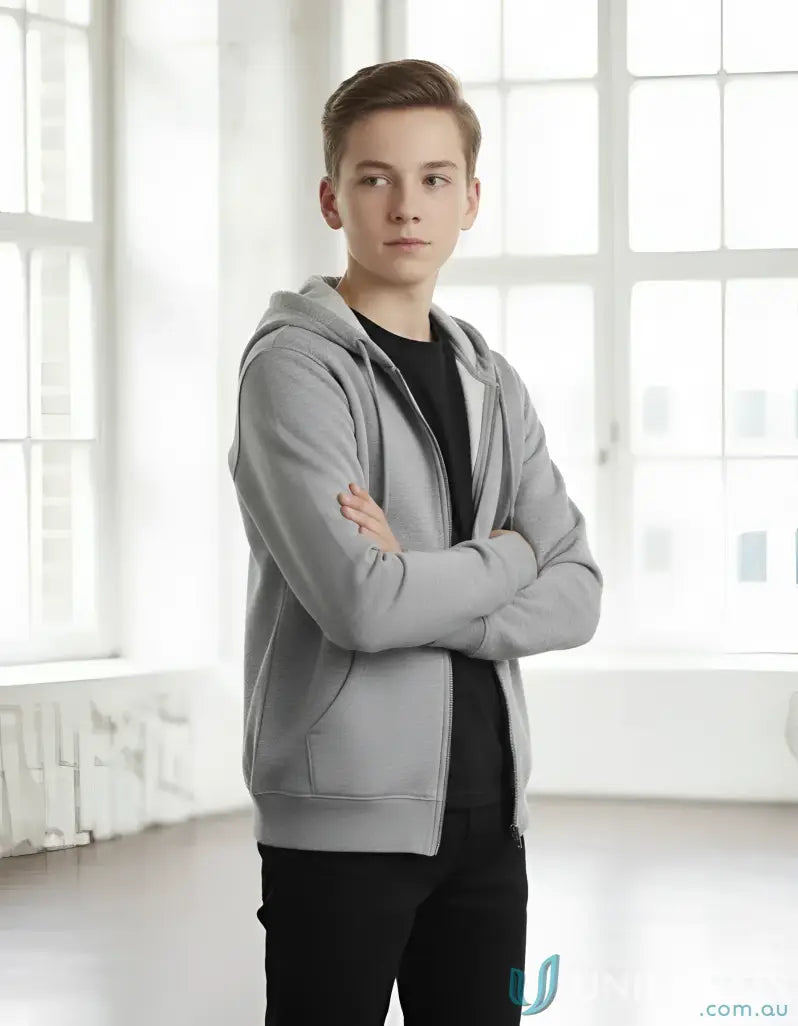 Young man in a light grey kids double bay hoodie with a winning spirit style