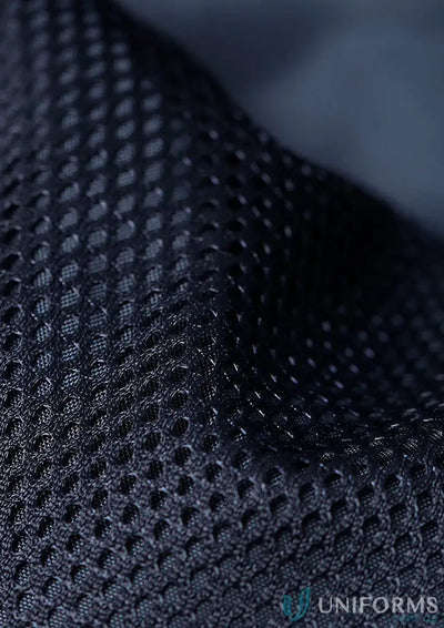 Close-up of breathable dark blue recycled PET bottles fabric in sustainable insulated puffer vest