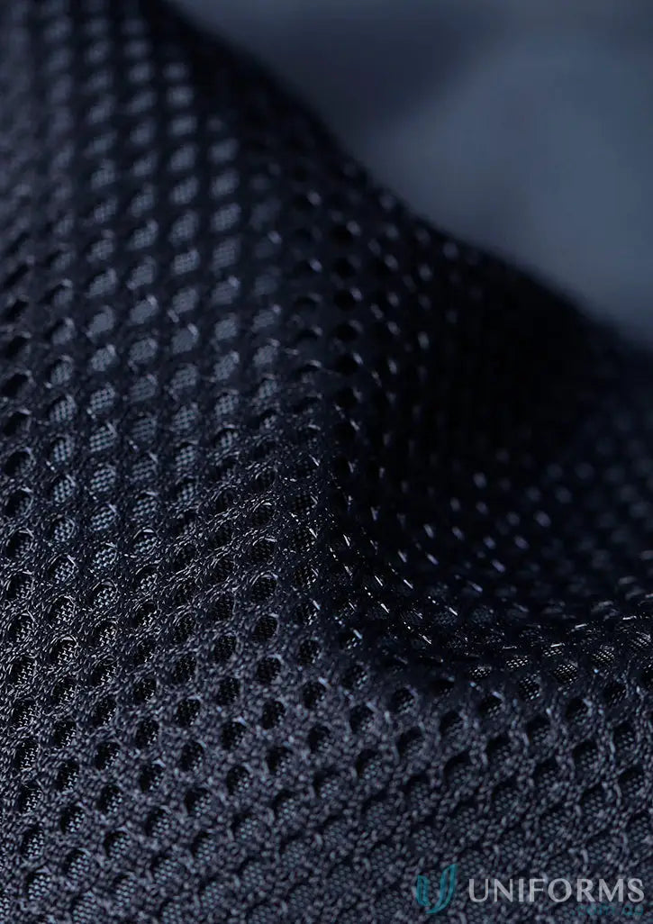 Close-up of breathable dark blue recycled PET bottles fabric in sustainable insulated puffer vest