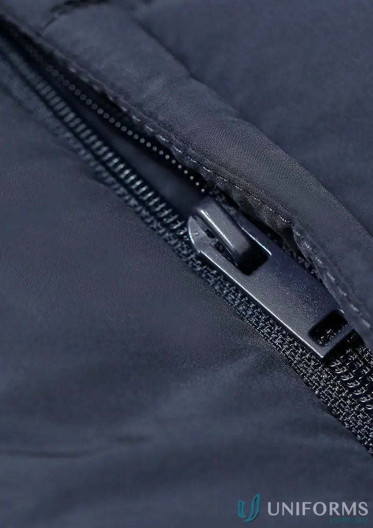 Dark blue sustainable insulated puffer vest with black zipper made from recycled PET bottles