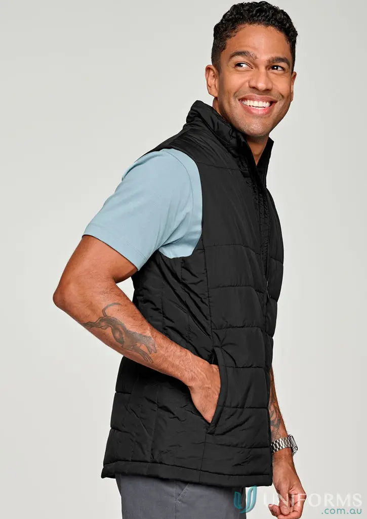 Smiling man wearing sustainable insulated puffer vest made from recycled PET bottles