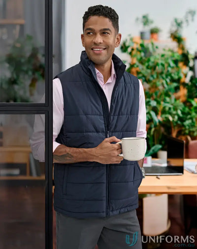 Man in navy blue sustainable insulated puffer vest made from recycled PET bottles holding a white mug