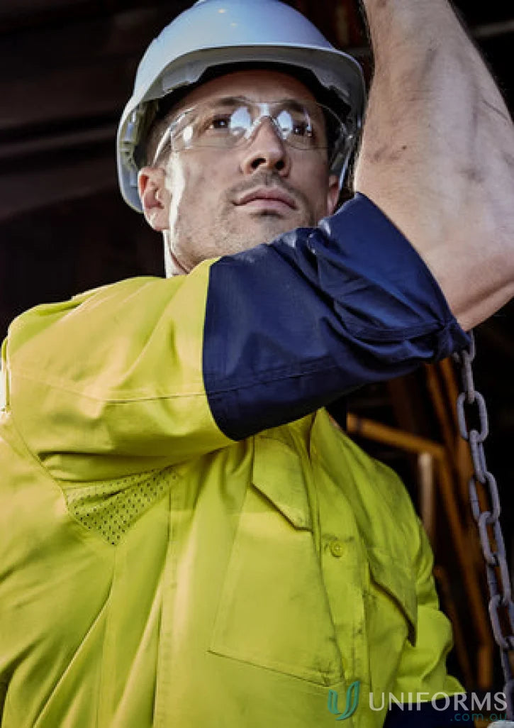 Construction worker in safety gear wearing Syzmik Men’s Rugged Cooling Vis Shirt ZW128 focusing on stress points