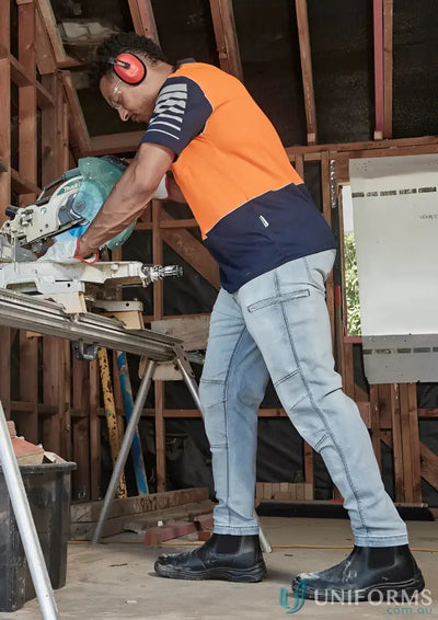 Construction worker using a saw in Syzmic HiVis Zone SS Polo with reflective piping