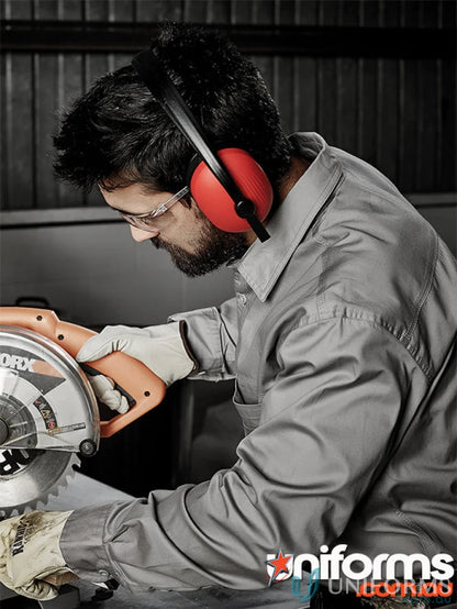 Man in Syzmic men’s lightweight tradie long sleeve cotton twill shirt using circular saw safely