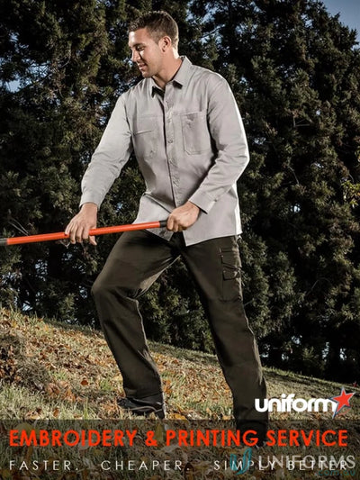 Man wearing Syzmik mens lightweight tradie long sleeve cotton twill shirt in work mode