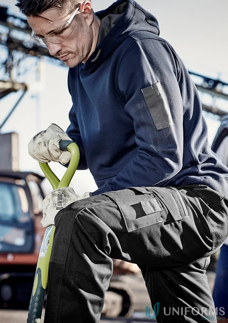 Man in workwear wearing Syzmic Multi-Pocket Hoodie with reinforced stress points and soft fleece lining