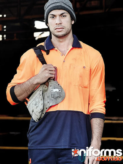 Man in workwear wearing Syzmik Unisex Sliced LS Polo, a Vis Basic Long Sleeve shirt