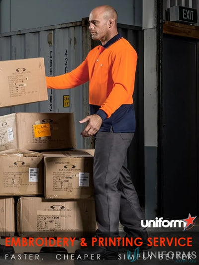 Man in work uniform lifting boxes wearing Syzmic Safety Sliced LS Polo, a vis basic long sleeveâsyzmik unisex style