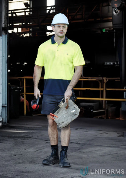 Construction worker in safety gear wearing Syzmic Safety Splice SS Polo, a vis basic short shirt
