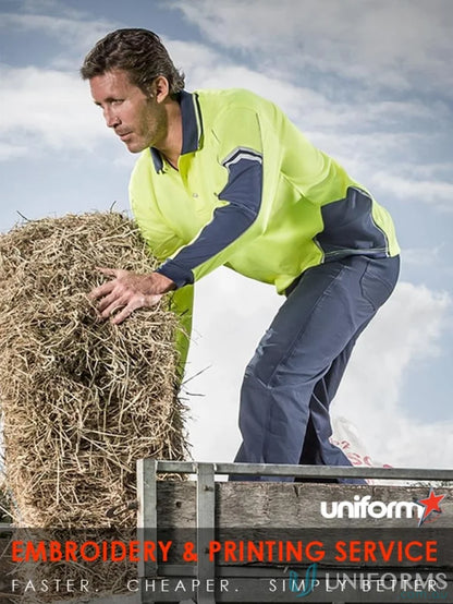 Man in workwear lifting hay bale wearing Syzmic Squad Long Sleeve Polo Zh238 for stay visible