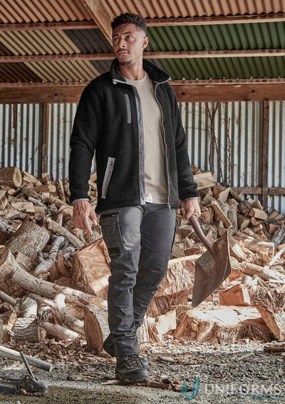 Man in black fleece jacket and heritage pant zp820 holding axe for streetworx heritage look