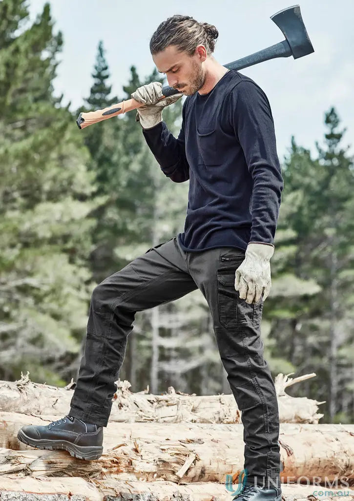 Man in streetworx heritage pant zp820 holding an axe, showcasing functional pants solve