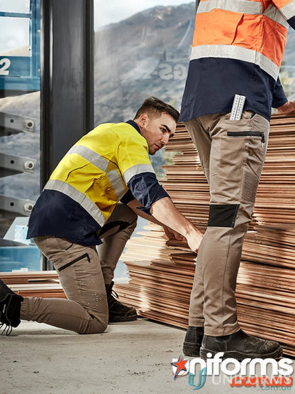 Construction workers in high-vis gear wearing Syzmik Men’s Streetworx Stretch Pant with stretch pleating