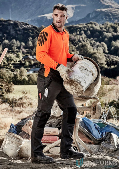 Construction worker wearing Syzmik Streetworx Tough pants showcasing durability meets ultimate strength