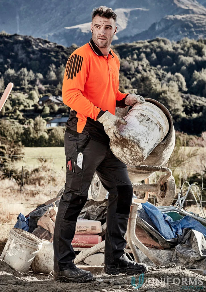 Construction worker wearing Syzmik Streetworx Tough pants showcasing durability meets ultimate strength