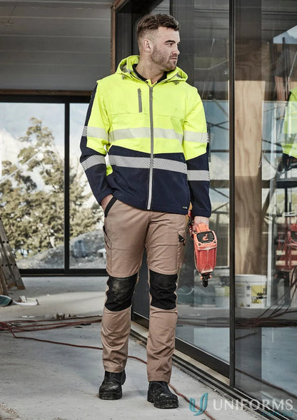 Construction worker in safety gear wearing Syzmik Streetworx Tough Pants for durability meets ultimate