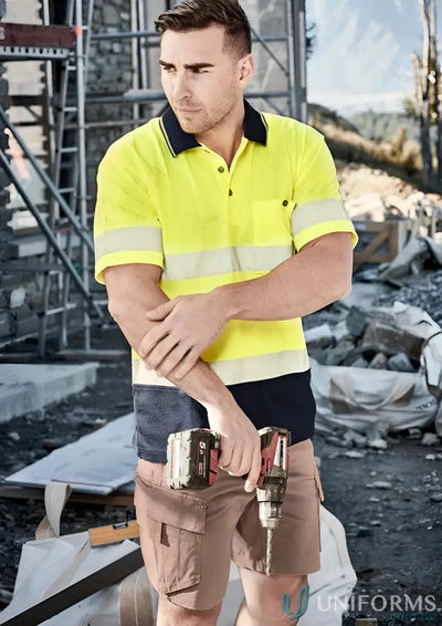 Construction worker holding a drill in Syzmic Unisex Hi Vis Segmented Tape SS Polo