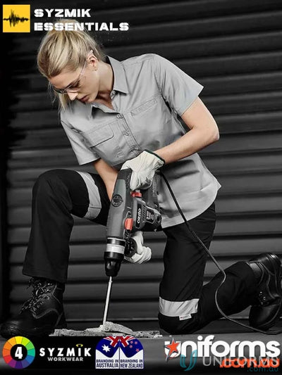 Woman using a power drill in Syzmik Women’s Lightweight SS Tradie Shirt for women