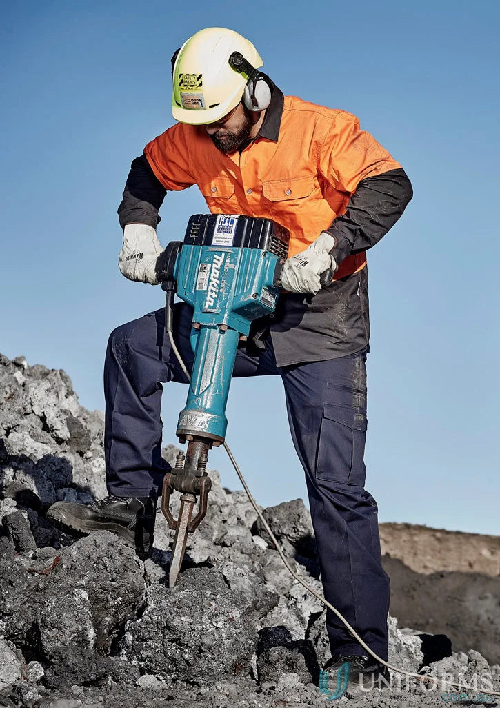 Man using teal jackhammer in Syzmik Men’s Cargo Pants ZP501 with reinforced stress points