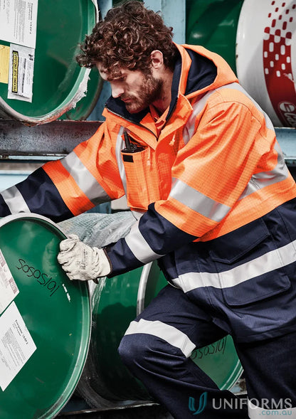 Man wearing Syzmik ZJ900 waterproof jacket, men’s orange flame arc rated antistatic gear