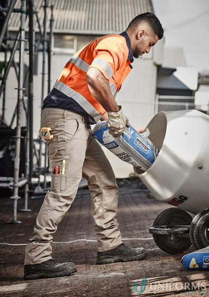 Construction worker pouring cement mix in Szyzik men’s rugged cooling cargo pants