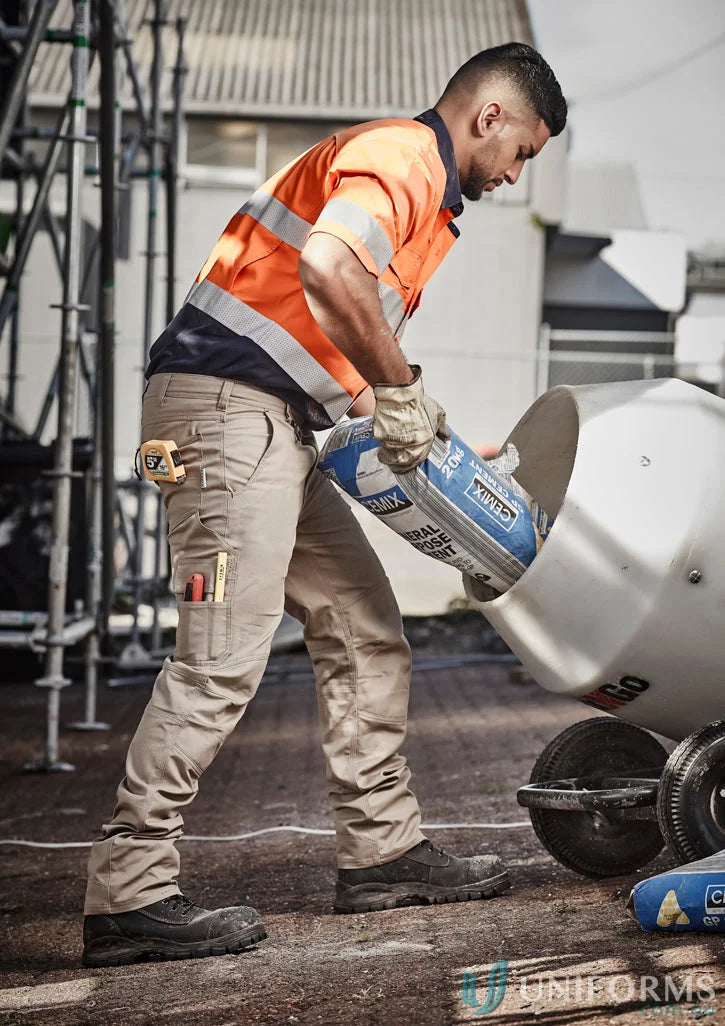 Construction worker pouring cement mix in Szyzik men’s rugged cooling cargo pants
