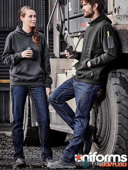 Two people wearing Syzmik Men’s Stretch Denim Work Jeans and dark hoodies outdoors