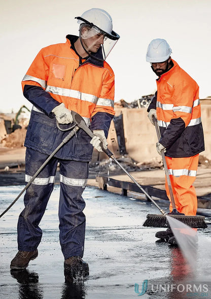 Two workers cleaning in Syzmik Taped Storm Pant ZJ352 for demanding outdoor conditions