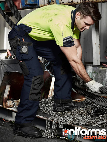 Workman in safety gear wearing Syzmik UltraLite Multi Pocket Pants with supersized tool belt
