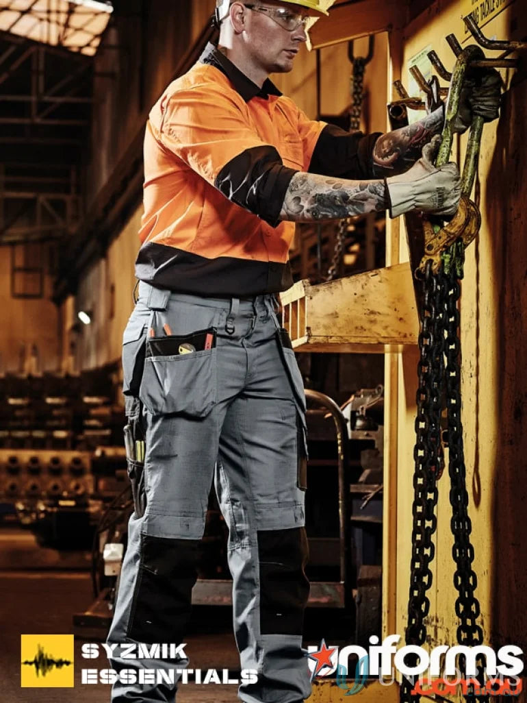 Workman wearing safety gear in Syzmik Ultralite Multi-Pocket Pants with supersized tool belt