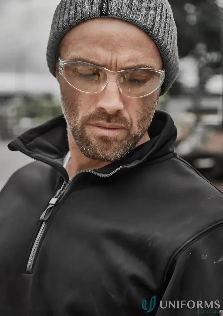 Man in safety glasses and beanie wearing Syzmik Unisex Streetworx Water Resistant Pullover