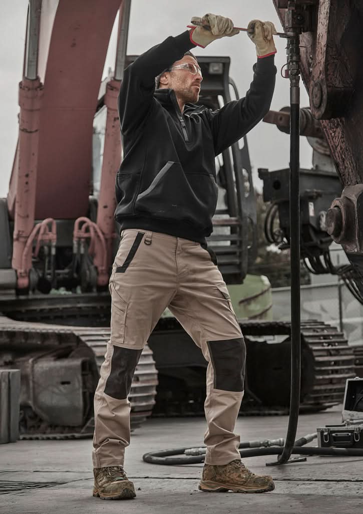 Man wearing Syzmik Unisex Streetworx Water Resistant 1/4 Zip Pullover in Black