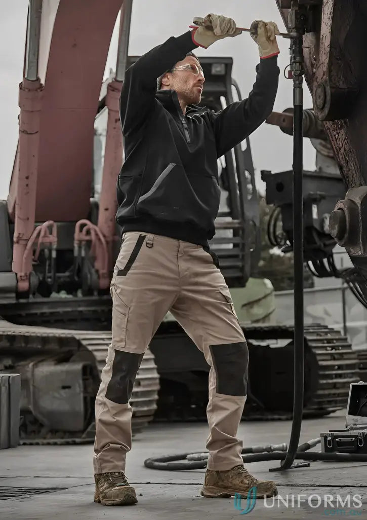 Man wearing Syzmik Unisex Streetworx Water Resistant 1/4 Zip Pullover in Black