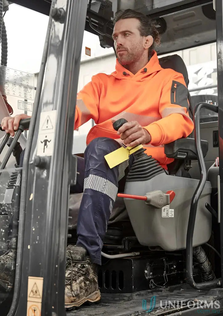 Construction worker in excavator wearing Syzmik Unisex Streetworx hoodie with segmented reflective tape